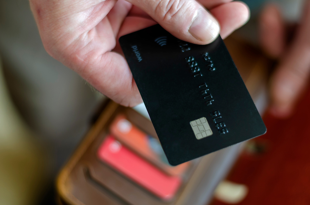 Hand Holds a Bank Card for Payment.